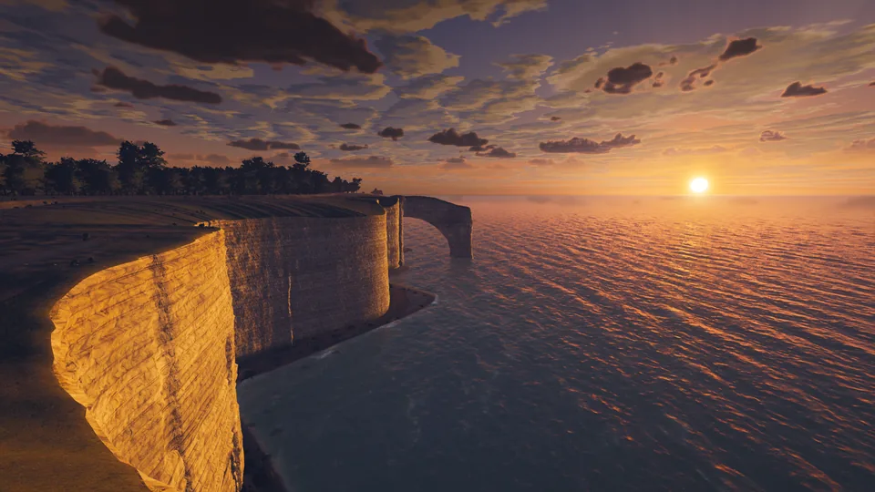 Chalk cliffs and a sea arch lit gold by the setting sun